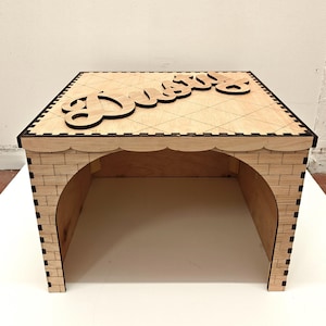 May include: A wooden pet step stool with the name "Dutchess" cut out on top. The step stool has a brick-like design on the sides and a decorative edge. The top is etched with a diamond pattern.