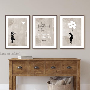 May include: Three framed prints with a beige background. The left print features a silhouette of a girl reaching for a heart-shaped balloon. The middle print features a quote that reads "What we do in life... echoes in eternity." The right print features a silhouette of a girl holding a bunch of balloons.