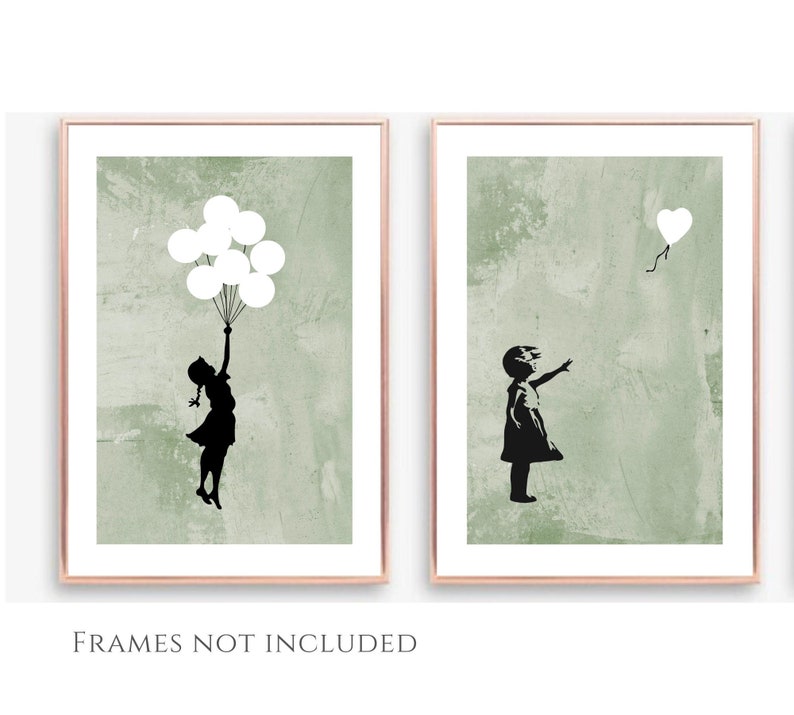 May include: Two framed prints of a girl with a black silhouette on a green background. The girl on the left is holding a bunch of white balloons. The girl on the right is reaching for a single white heart-shaped balloon.
