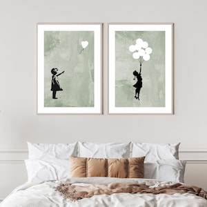 May include: Two framed prints with a green background and a black silhouette of a girl. One print shows a girl reaching up to a heart-shaped balloon. The other print shows a girl holding onto a bunch of balloons.
