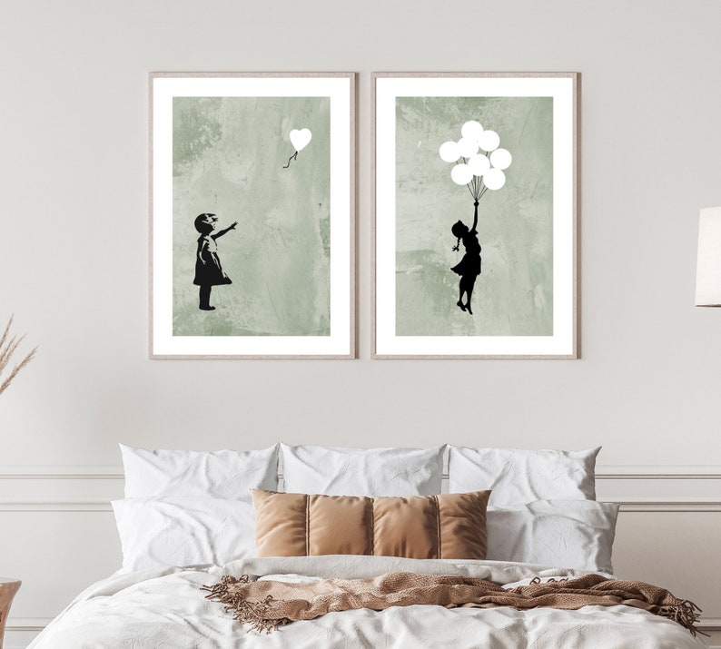 May include: Two framed prints with a green background and a black silhouette of a girl. One print shows a girl reaching up to a heart-shaped balloon. The other print shows a girl holding onto a bunch of balloons.