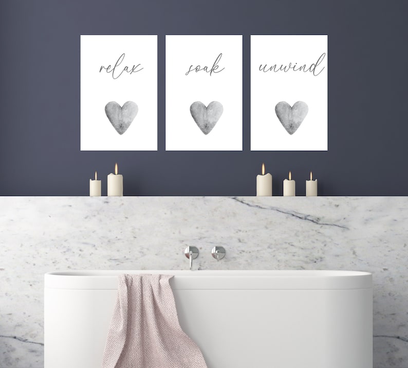 May include: Three white framed prints with black text and gray watercolor hearts. The prints read "relax", "soak", and "unwind".