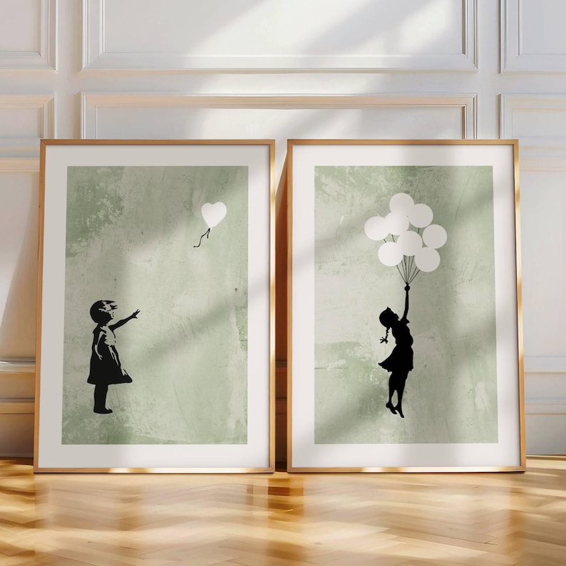 May include: Two framed prints with a green background. Each print features a silhouette of a girl. One girl is reaching for a single white heart-shaped balloon. The other girl is holding onto a bunch of white balloons.