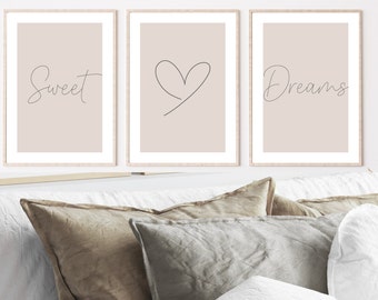 May include: Three framed prints with a light beige background. The left print has the word "Sweet" written in cursive. The middle print has a simple line drawing of a heart. The right print has the word "Dreams" written in cursive.
