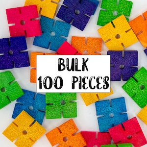 May include: A close-up of 100 colorful wooden puzzle pieces in various shapes. The pieces are arranged in a circle around a white card with the text "BULK 100 PIECES" printed in black.