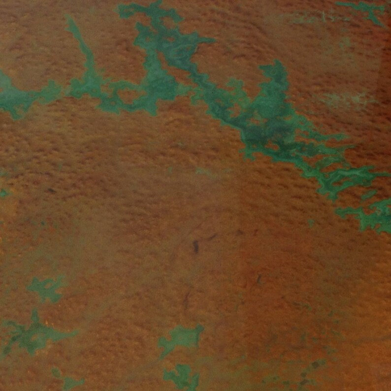 May include: An aerial view of a landscape with a large area of green vegetation surrounded by a brown, dry area.