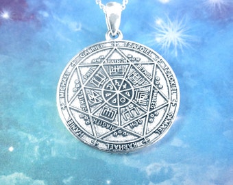 May include: Silver pendant necklace featuring a circular design with an intricate pattern and the names of archangels inscribed around the perimeter. The names include Michael, Gabriel, Raphael, Samael, Tzaphkiel, and others.