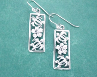 May include: Silver earrings with a rectangular design featuring three sea turtles and plumeria flowers.