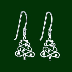 May include: A pair of silver-colored Christmas tree earrings. Each earring features a stylized tree design with decorative swirls and star accents, suspended from a simple hook.