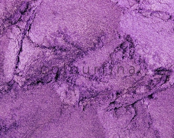 May include: Close-up of a pile of purple mica powder. The powder has a fine, shimmery texture.