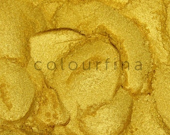 May include: Close-up of a golden metallic powder with a textured, shimmering surface. The powder is a vibrant gold color and has a fine, smooth texture.