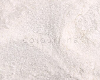May include: A close-up of a white, shimmery powder. The powder has a fine, glittery texture and is perfect for adding sparkle to crafts and projects.
