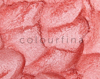 May include: Close-up of a shimmery, metallic pink eyeshadow. The texture is smooth and finely milled, with a subtle sparkle.