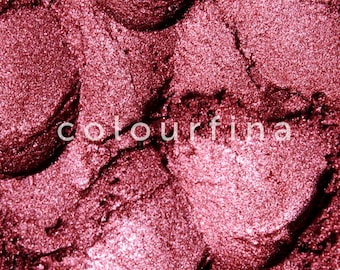 May include: Close-up of a deep red eyeshadow with a shimmery finish. The texture is smooth and appears to be finely milled.