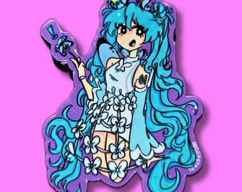 May include: A die-cut sticker featuring a cartoon anime character with long, flowing turquoise hair and a white dress adorned with flowers. The character is set against a purple background, with the number "01" visible. The sticker has a holographic effect.