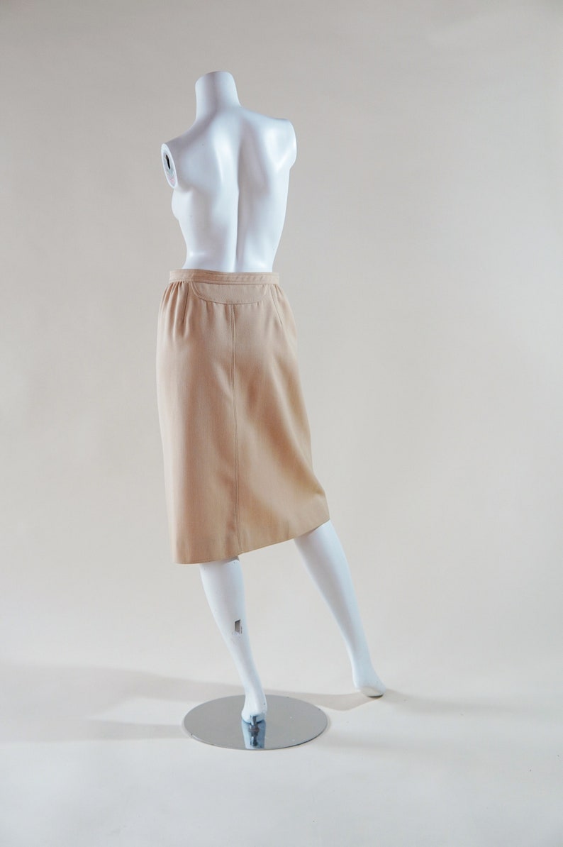 1970s Courrèges wrap skirt tan beige vintage designer knee length skirt with silver buttons and leather nameplate logo at waist image 4