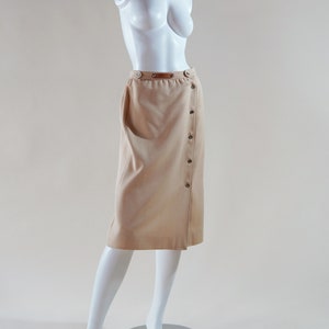 1970s Courrèges wrap skirt tan beige vintage designer knee length skirt with silver buttons and leather nameplate logo at waist image 2