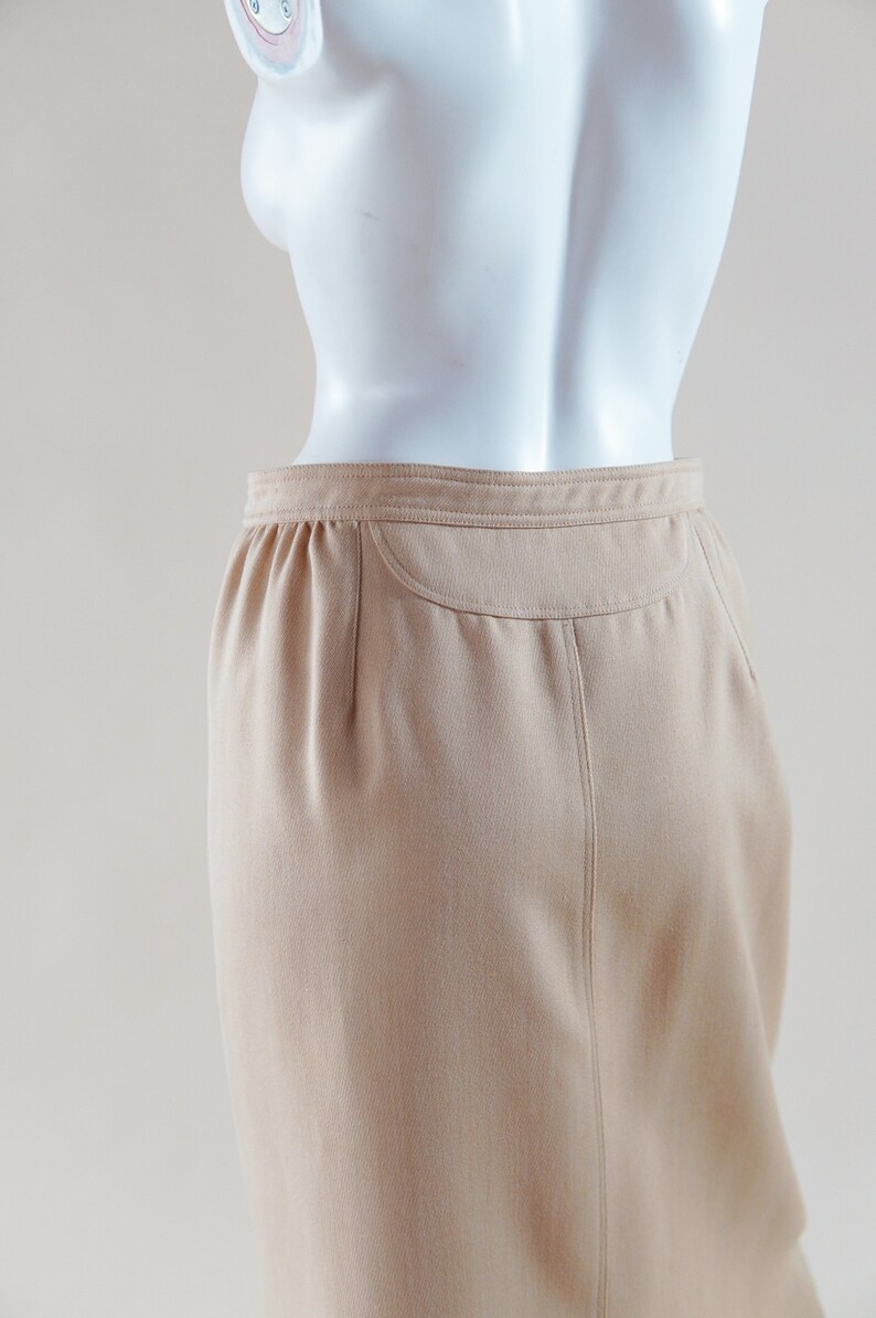 1970s Courrèges wrap skirt tan beige vintage designer knee length skirt with silver buttons and leather nameplate logo at waist image 6