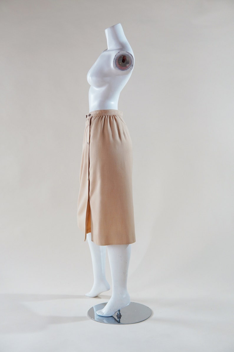 1970s Courrèges wrap skirt tan beige vintage designer knee length skirt with silver buttons and leather nameplate logo at waist image 3