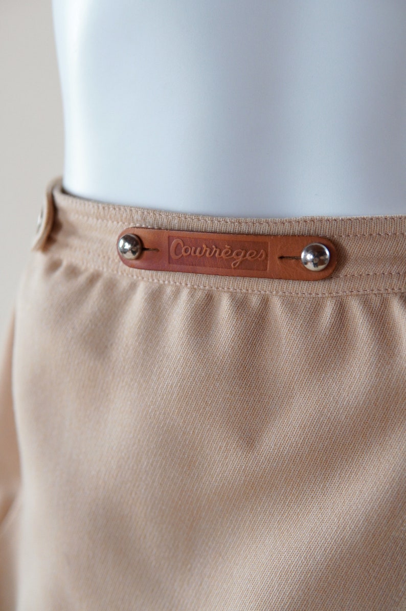 1970s Courrèges wrap skirt tan beige vintage designer knee length skirt with silver buttons and leather nameplate logo at waist image 7