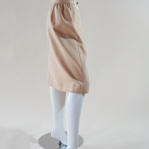 1970s Courrèges wrap skirt tan beige vintage designer knee length skirt with silver buttons and leather nameplate logo at waist image 5