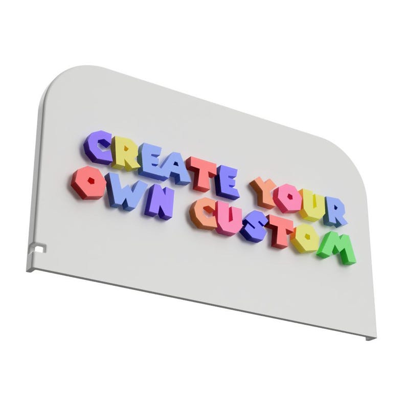 May include: A white sign with rounded corners features the text "CREATE YOUR OWN CUSTOM" in colorful, 3D block letters. The letters are in various colors, including yellow, blue, red, and green.