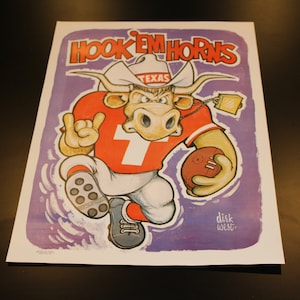 May include: A cartoon illustration of a Texas Longhorn bull wearing a red and white football uniform with the word "TEXAS" on the hat. The bull is holding a football and has a determined expression on its face. The background is purple with the words "HOOK 'EM HORNS" at the top and "DIRK WEST" at the bottom.