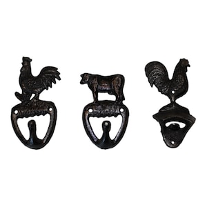 May include: Three black cast iron bottle openers with a rooster, cow, and rooster design. Each opener has a hook for hanging.