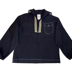 May include: A black long-sleeved shirt with a sailor collar and gold trim. The shirt has a single pocket on the left chest.
