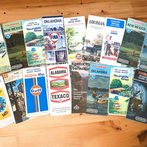 May include: A collection of vintage travel maps from the 1960s and 1970s. The maps are from various states and regions of the United States, including Oklahoma, New Mexico, Alabama, Louisiana, and Colorado. The maps are printed on paper and feature a variety of colors, including blue, red, green, and yellow. The maps are in good condition and would be a great addition to any vintage travel collection.