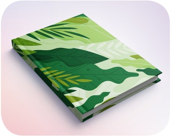 May include: A green and white notebook with a tropical leaf pattern. The notebook is closed and lying on a white surface.