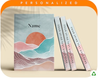 May include: A personalized journal and three matching notebooks. The journal features a watercolor landscape design with a sunset and mountains. The spines of the notebooks read "YOUR SPINE TEXT GOES HERE". The word "PERSONALIZED" is at the top.
