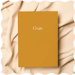 May include: A mustard yellow notebook with the word "Gvan" printed in white on the front cover.