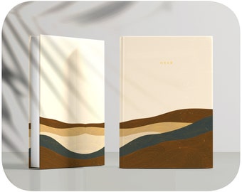 Puede incluir: Dos libros encuadernados en tapa dura cerrados con una cubierta beige y un diseño abstracto marrón, beige y azul en la mitad inferior de la cubierta. El libro de la derecha tiene la palabra "GYAN" impresa en dorado en la mitad superior de la cubierta.
