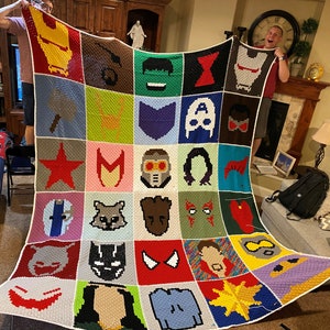May include: A colorful crocheted blanket featuring squares with different Marvel characters, including Iron Man, Captain America, Thor, Hulk, Black Widow, and more.