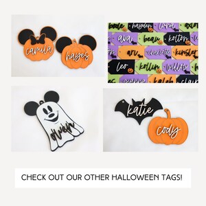 May include: A set of Halloween-themed wooden tags with various designs, including a pumpkin, a ghost, and a bat. The tags are painted in black, orange, and white and feature personalized names like "Camila", "Hayes", "Cody", and "Katie".