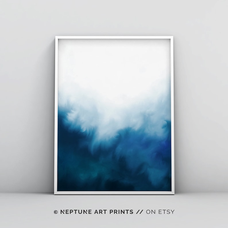 May include: Abstract art print with a white background and a gradient of blue shades, transitioning from light blue to dark blue. The print is framed in a white frame.