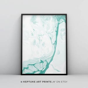 May include: Abstract art print featuring a teal and white marbled design. The print is framed in a black frame.
