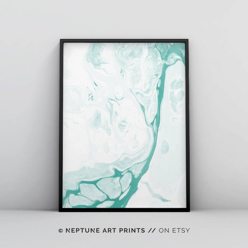 May include: Abstract art print featuring a teal and white marbled design. The print is framed in a black frame.
