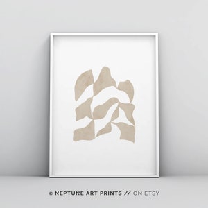 May include: Abstract art print featuring a beige geometric shape on a white background. The print is framed in a white frame. The text "NEPTUNE ART PRINTS // ON ETSY" is at the bottom of the image.