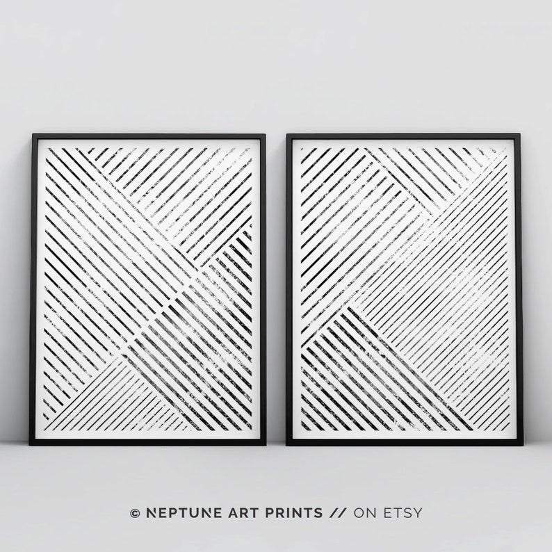 May include: Two black and white abstract geometric prints in black frames. The prints feature a pattern of diagonal lines and squares.