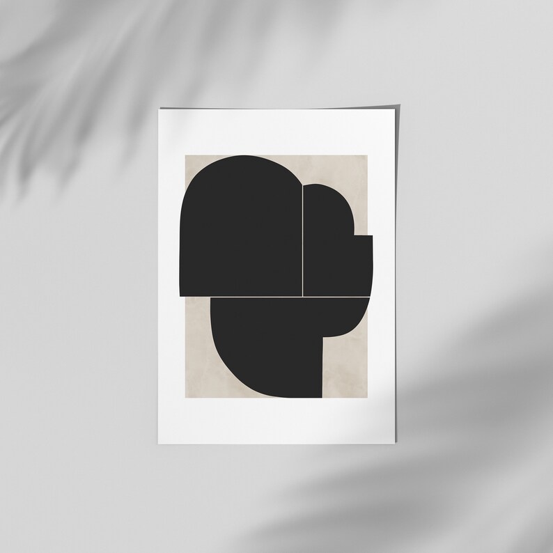 May include: Abstract art print featuring a black geometric shape on a beige background.