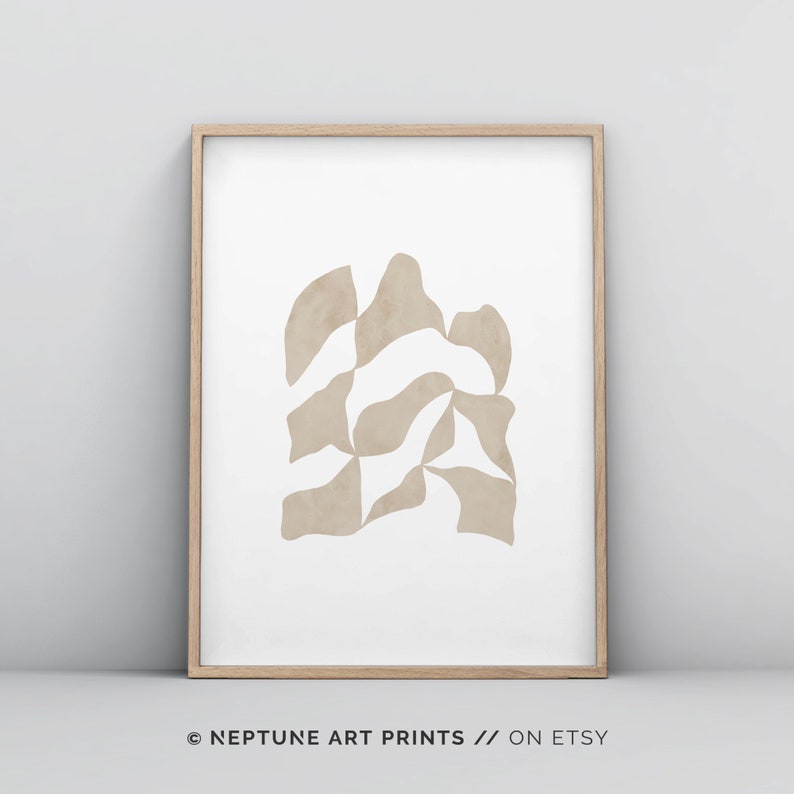 May include: Abstract art print featuring a beige geometric design on a white background. The print is framed in a light wood frame. &copy; NEPTUNE ART PRINTS // ON ETSY