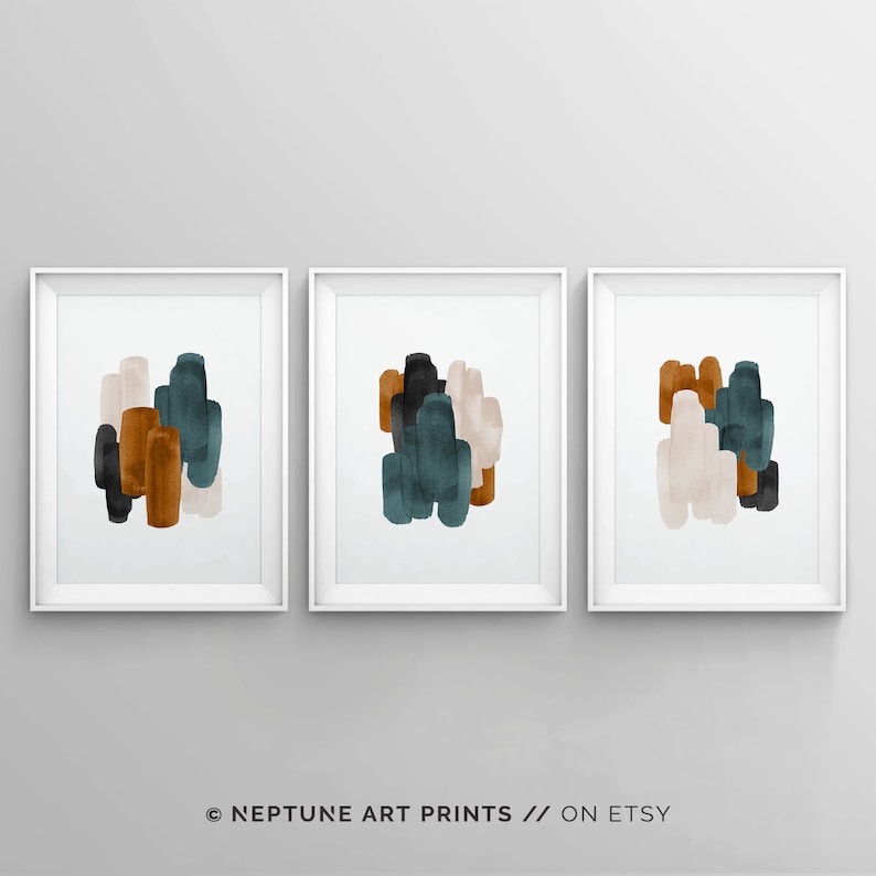 May include: Set of three abstract art prints featuring a modern design with teal, brown, and beige watercolor shapes. The prints are framed in white.