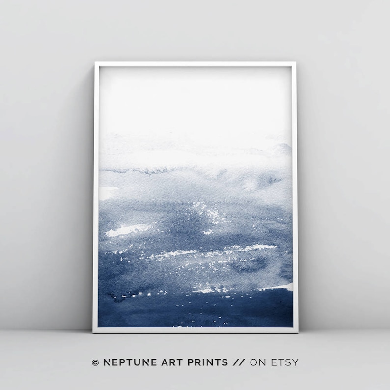 May include: Abstract watercolour painting in shades of blue, with a white frame. The painting features a gradient of blue hues, from light to dark, creating a sense of depth and movement. The artwork is perfect for adding a touch of modern art to any space.