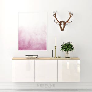 May include: White cabinet with three doors, a pink watercolor print, a wooden deer head mounted on the wall, and a vase with green plants on top of the cabinet.