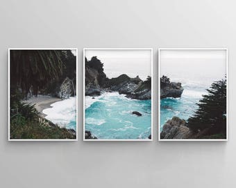 May include: A three-part panoramic photograph of a rocky coastline with turquoise water crashing against the shore. The image is divided into three sections, each showing a different perspective of the coastline. The first section shows a beach with green foliage and a rocky cliff. The second section shows the turquoise water crashing against the rocks. The third section shows a rocky cliff with green foliage.