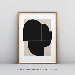 May include: A black and white abstract geometric print with a beige background. The print features overlapping shapes in a modern style.