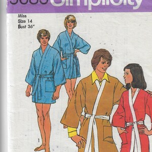 May include: Simplicity sewing pattern number 5685 for a robe. The pattern includes instructions for three different styles of robes: a blue robe, a brown robe with a white sash, and a red robe with a white sash. The pattern is for a size 14, bust 36 inches.