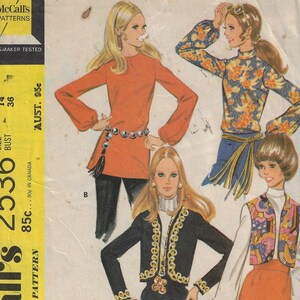 May include: Vintage sewing pattern for a misses' and junior blouse, vest, and jacket. The pattern includes four different styles: a red blouse with long sleeves, a floral print blouse with long sleeves, a black vest with gold trim, and a red vest with a floral print. The pattern is from McCall's and is size 14, bust 36 inches.